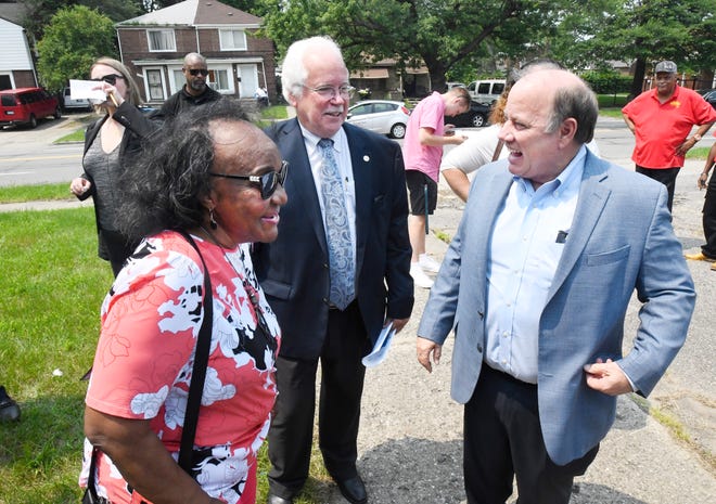 Wayne County Commissioner Irma Clark-Coleman, PVM President and CEO Roger Myers and Detroit Mayor Mike Duggan talk before a July 2021 press conference announcing an affordable housing project will be built on the former site of Lewis College of Business. There is a proposal to reopen the college elsewhere in Detroit -- a proposal Duggan supports.