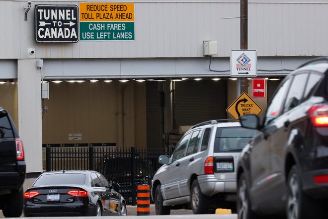 In this March 16, 2020, file photo, vehicles enter the Detroit-Windsor Tunnel in Detroit to travel to Canada.
