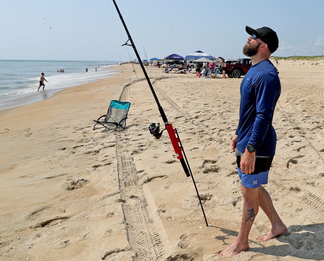 Bruce Werkheiser checks his line for surf fishing Friday, July 16, 2021, on Fenwick Island State Park in Fenwick Island, Delaware.