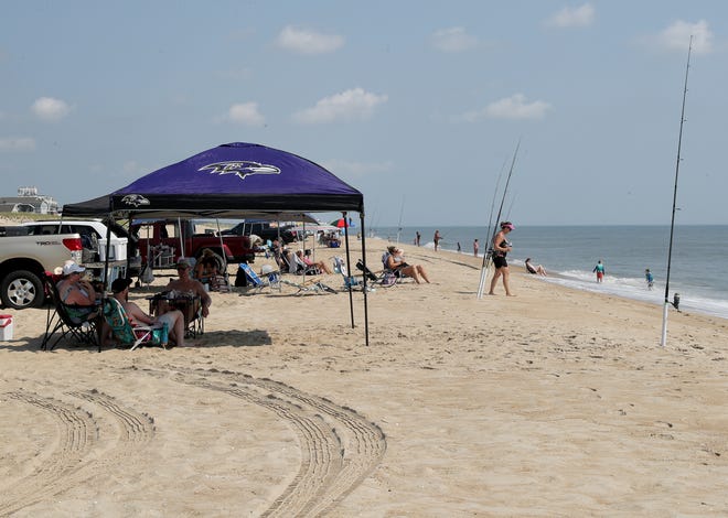 Surf fisher line up along the beach Friday, July 16, 2021, on Fenwick Island State Park in Fenwick Island, Delaware.