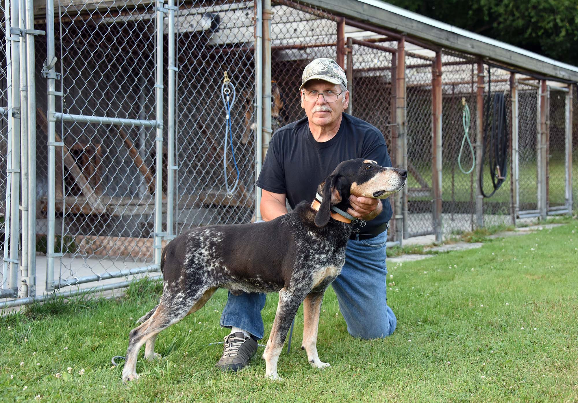 Greg "Sparky" McClellan of Stoystown holds his coon dog Jennings outside his kennel near Stoystown.