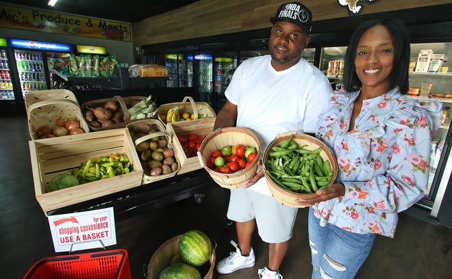 Owners Chyncia and Micholas Rodgers show off the fresh produce for sale inside Mic's Mini Market on West May Avenue Tuesday afternoon, July 20, 2021.