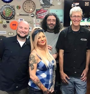 Prost! owners Chris Tynan and his sister Elyse Wilson, along with former employee Shawne Cooke, got a surprise visit from Sean Lawson, right, of Lawson's Finest Liquids to their specialty beer and wine shop a few years back.