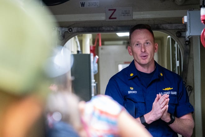 Lt. Cmdr. Stephen Brickey, captain of the USCGC Hollyhock, right, leads a tour through the ship's deck Tuesday, July 20, 2021.