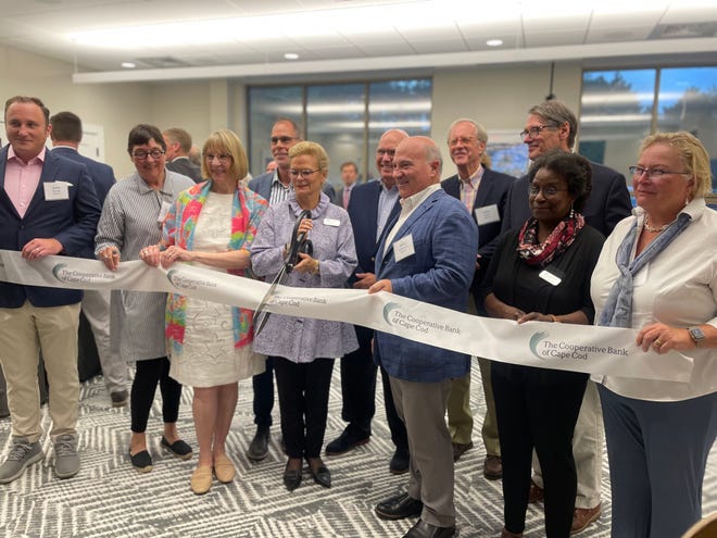 Lisa Oliver, president, chair and CEO of The Cooperative Bank of Cape Cod, and boad members officially open the bank's newly renovated headquarters in Hyannis on Monday.