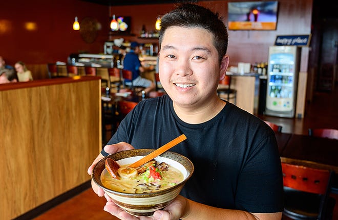 Ginger Bistro owner and chef Tuna Liu holds a bowl of Pork Tonkotsu Ramen noodles in the dining room of his restaurant in St. Augustine on Tuesday.