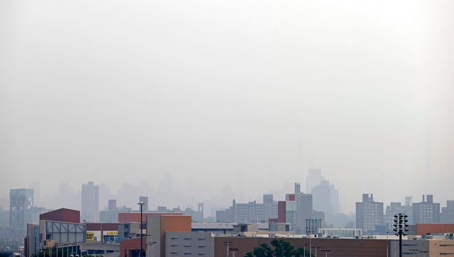 Smoke blocks the view looking toward Manhattan from Yankee Stadium before the Philadelphia Phillies played the New York Yankees in a baseball game Tuesday, July 20, 2021, in New York. (AP Photo/Adam Hunger)
