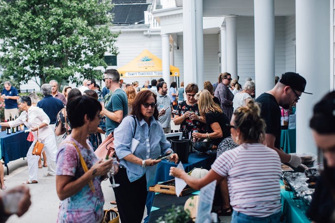 A crowd enjoys various foods at the Southern Delaware Wine, Food & Music Festival in Millsboro in 2019.