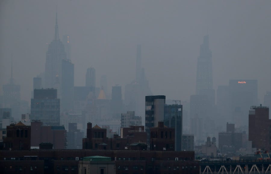 A thick haze hangs over Manhattan, Tuesday, July 20, 2021, in New York. Wildfires in the West are creating hazy skies as far away as New York as the massive infernos spew smoke and ash into the air in columns up to six miles high.