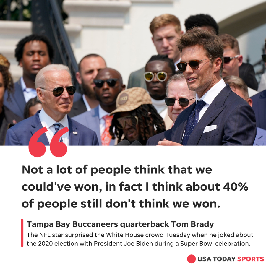 President Joe Biden, surrounded by members of the Tampa Bay Buccaneers, listens as Tampa Bay Buccaneers quarterback Tom Brady speaks during a ceremony at the White House, in Washington, on  July 20, 2021.