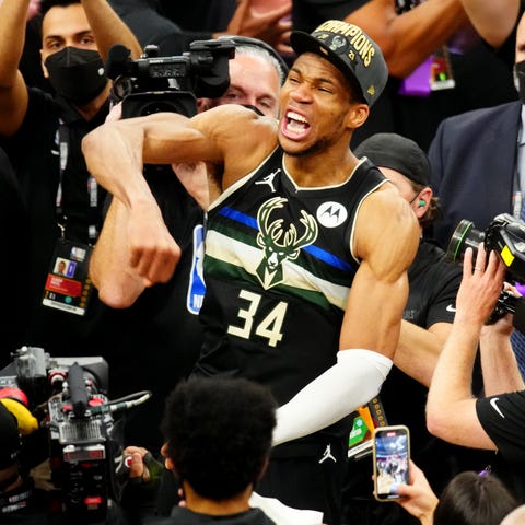 Giannis Antetokounmpo celebrates his first NBA cha