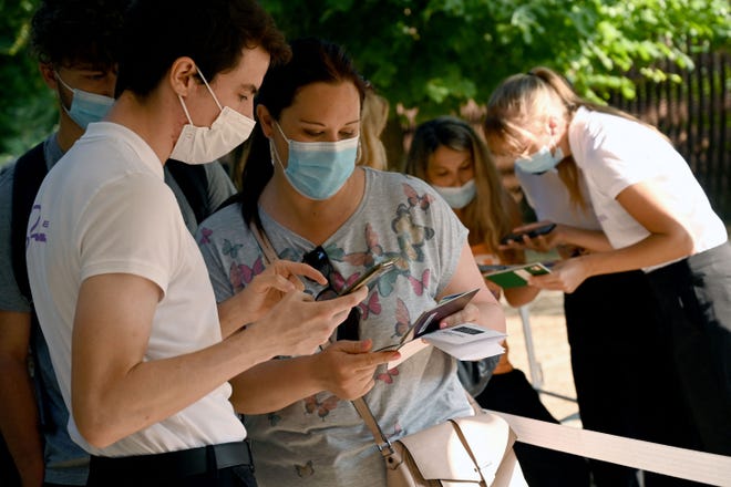 Eiffel Tower employees check health passes before tourists visit the Paris landmark on July 21, 2021.