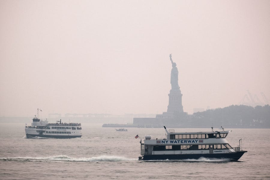 The Statue of Liberty sits behind a cloud of haze on July 20, 2021 in New York City. According to data from the National Oceanic and Atmospheric Administration, wildfire smoke from the west has arrived in the tri-state area creating decreased visibility and a yellowish haze in many areas.