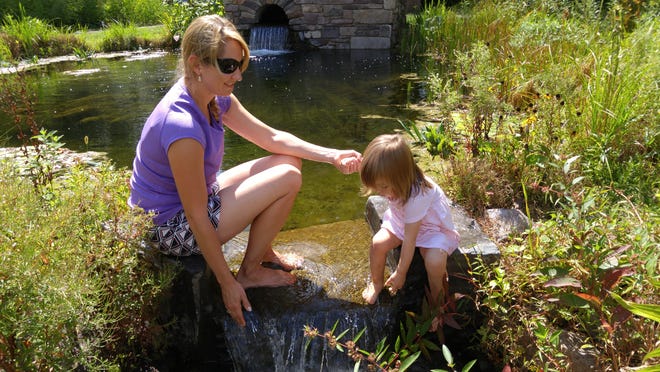Author's daughter Genevieve and granddaughter Margaux cool off near a pump house (background) that feeds remarkable ponds at Bowman's Hill Wildflower Preserve in Solebury.