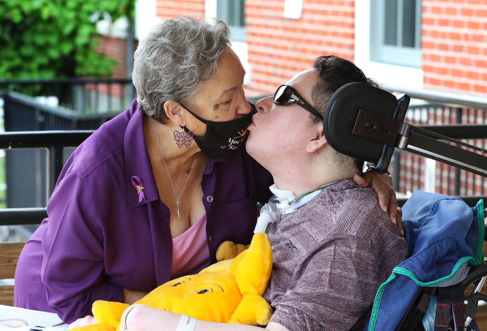 Shirley Pacheco visits her son Adam Pacheco, 43, at the Zambarano Unit of Eleanor Slater Hospital, where he has lived for 26 years. A car crash when he was 17 left him a quadriplegic, unable to speak because of the surgically inserted breathing apparatus that connects him to oxygen.