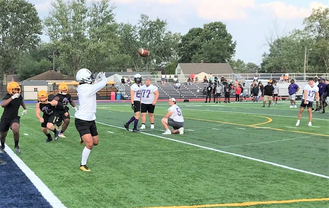 Bloom-Carroll quarterback KJ Benedict throws a touchdown pass to Beau Wisecarver during the Bulldogs' 7-on-7 passing scrimmage against Reynoldsburg Wednesday at Bishop Hartley.