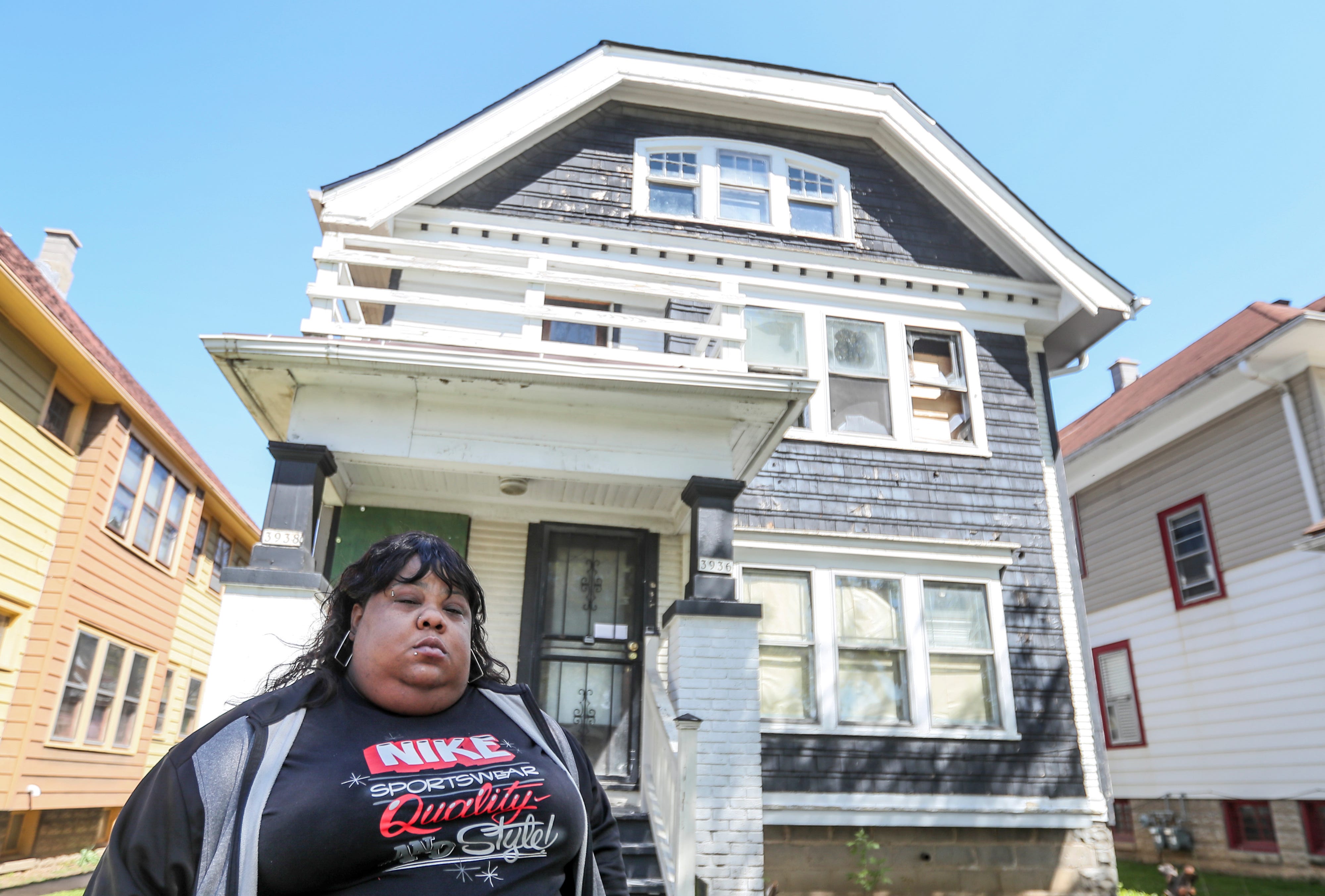 Tiffany McCarver outside the home on North 14th Street where her mother, Patricia Colston, died in a fire.