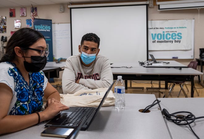 Carlos Rene Castro, helps two students during a journalism workshop at Salinas High School on Monday, July 19, 2021. 