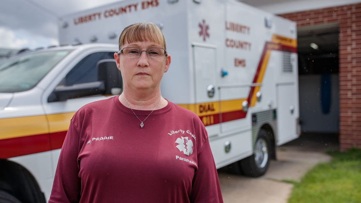 Melissa Peddie, Liberty County, ambulance director in Liberty County, Florida, stands in front  of the county's only active ambulance Wednesday, July 21, 2021.