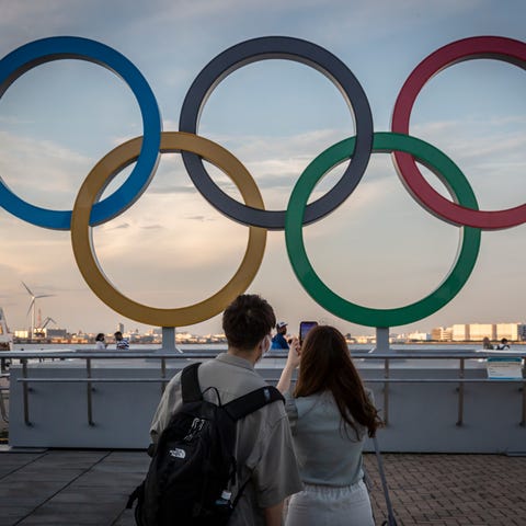 People take photographs of Olympics rings.