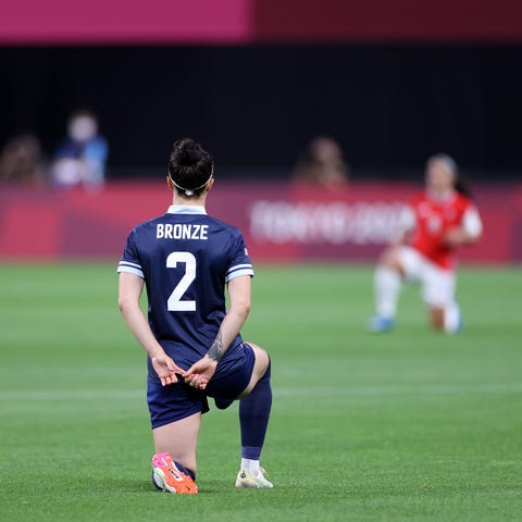 Great Britain's Lucy Bronze takes a knee before We