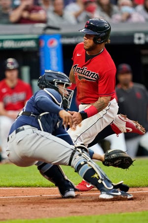 Cleveland's Harold Ramirez, right, scores as Tampa Bay Rays catcher Francisco Mejia is late on the tag during the fourth inning of a baseball game Thursday, July 22, 2021, in Cleveland. (AP Photo/Tony Dejak)