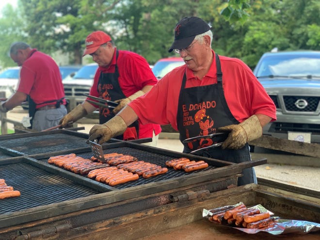 The El Dorado Red Devil Chefs prepare hot dogs for National Night Out 2019.