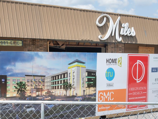 A sign announces a new Home2 Suites by Hilton coming soon to the location of the former Miles Antique Mall on Bayou Boulevard in Pensacola.