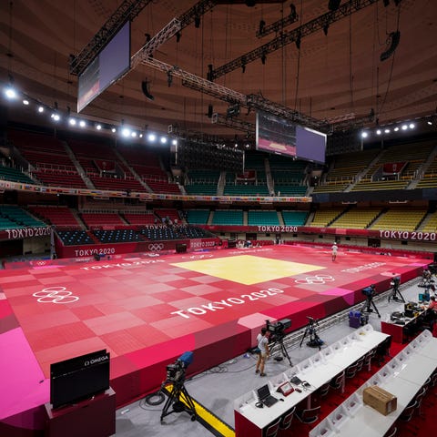 People prepare the field of play for judo at the N