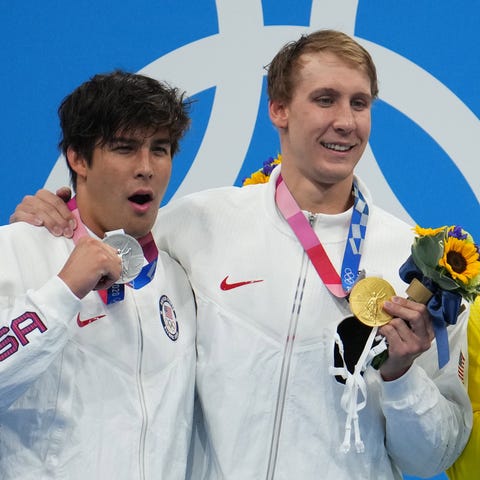 Men's 400 meter IM medalists Jay Litherland, left,