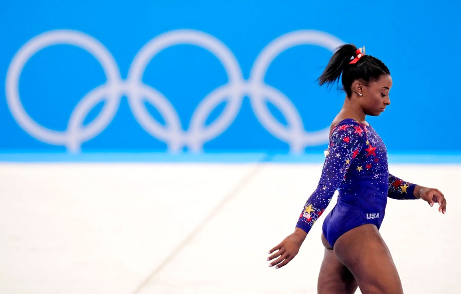 Simone Biles walks onto the floor in the women's gymnastics qualifications during the Tokyo 2020 Olympic Summer Games at Ariake Gymnastics Centre.