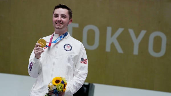 July 25: William Shaner holds the gold medal after