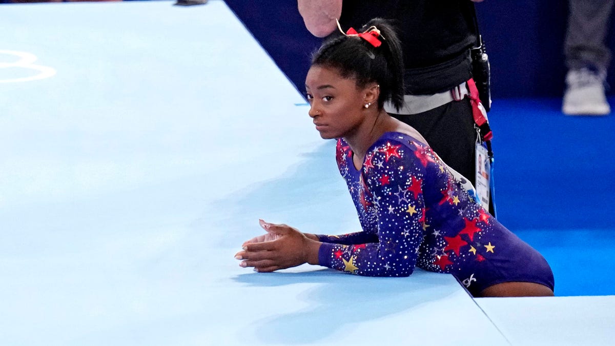 Simone Biles prepares to compete on the floor Sunday in the women's gymnastics qualifications.
