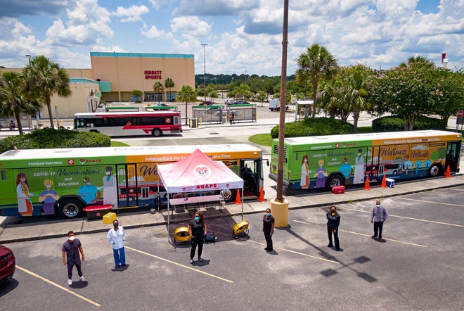 The Jacksonville Transportation Authority's Wellness on Wheels, shown here with two buses at Gateway Town Center, is a partnership with Agape Family Health to bring COVID-19 vaccines into the community.