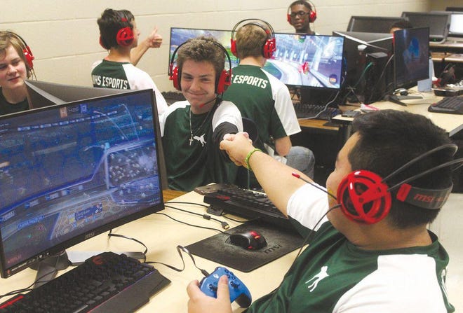 Jordan Deuley gives a fist bump to Van Buren Esports teammate Joseph Calderon during a Rocket League match. STEM, media, and eSports are among the many activities offered at several schools in the River Valley this fall.