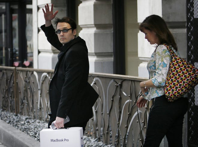 Aug. 20, 2011: Damien Echols waves to a few onlookers and members of the media as he and his wife, Lorri Davis, leave the Madison Hotel a day after the release of the West Memphis Three. Echols and Jason Baldwin departed the hotel about noon with supporters including Pearl Jam front man Eddie Vedder.