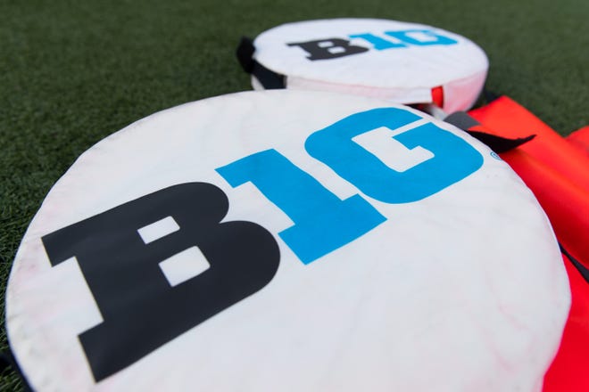 Big Ten logo on yardage markers during warmups prior to a Wisconsin game at Camp Randall Stadium.