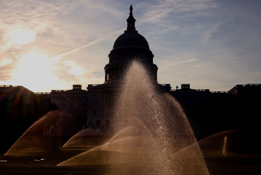 Sprinklers water the West Front of the U.S. Capitol Building on July 26, 2021, in Washington, DC, as the Senate works towards finalizing the bipartisan infrastructure bill.