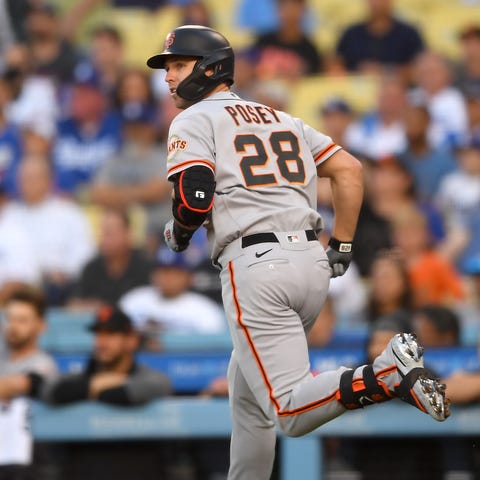 Buster Posey rounds the bases after hitting a home