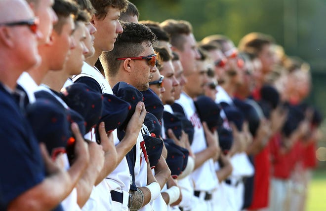 Cherryville Post 100 baseball players stand at attention during the 2019 state American Legion Baseball tournament.