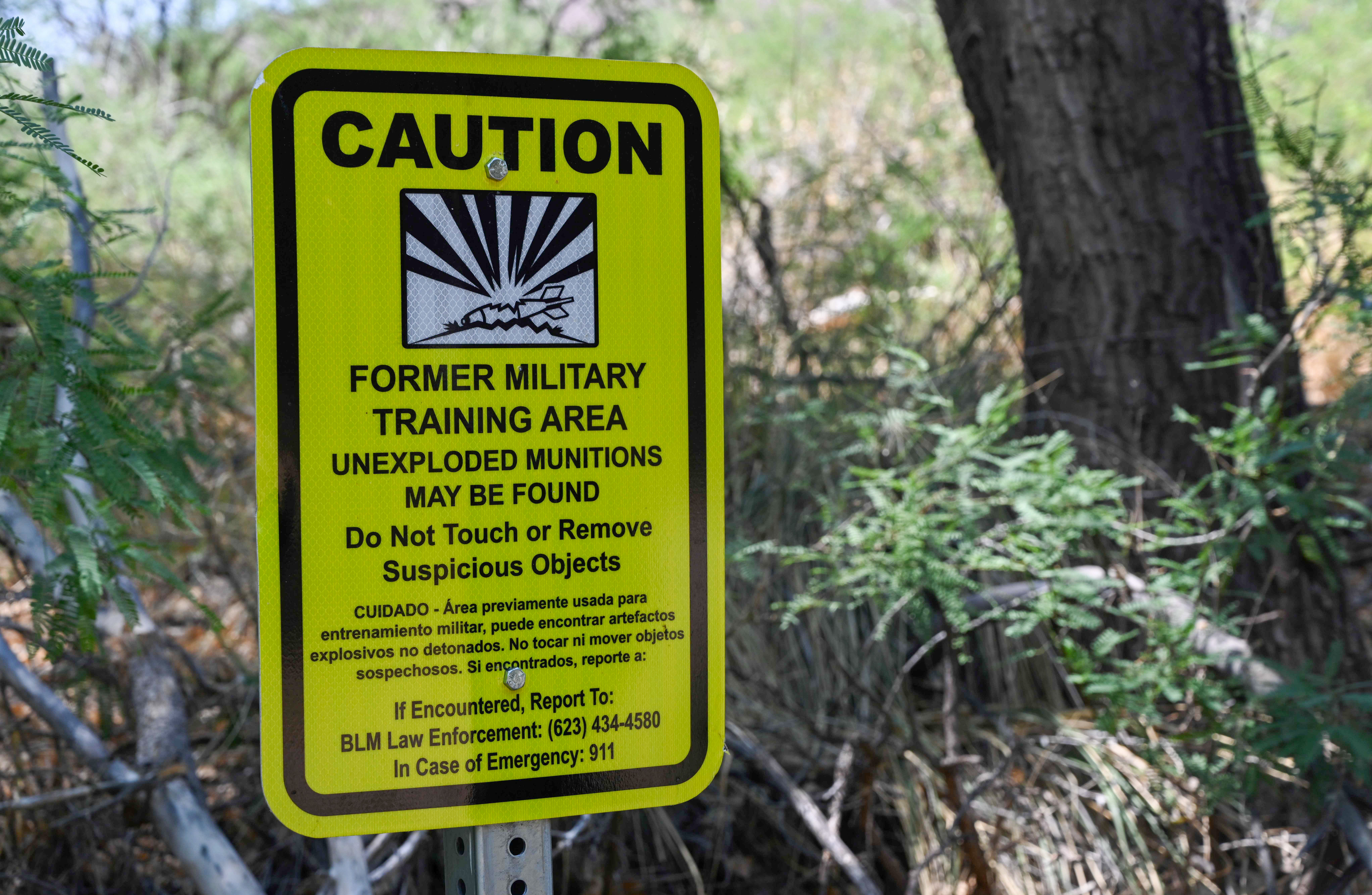 A sign beside the San Pedro River warns people about unexploded munitions in a former military training area. The river runs near the Army base at Fort Huachuca.