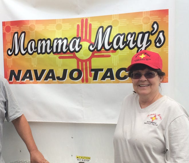 Linda Moody-Ivey stands next to a Momma Mary's Navajo Tacos sign in this News-Leader file photo.