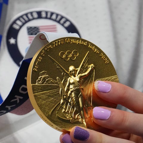Lydia Jacoby holds her gold medal during the medal