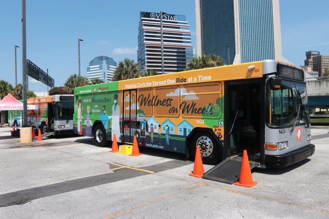 A bus donated by the Jacksonville Transportation Authority serves as a mobile COVID-19 vaccination site for the Wellness on Wheels event on Wednesday at the parking lot of the former Jacksonville Landing.