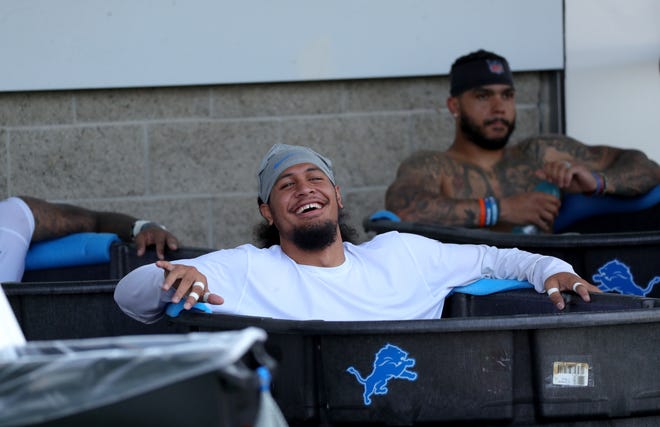 Lions linebacker Jahlani Taval cools off after training camp at the Allen Park facility on Wednesday, July 28, 2021.