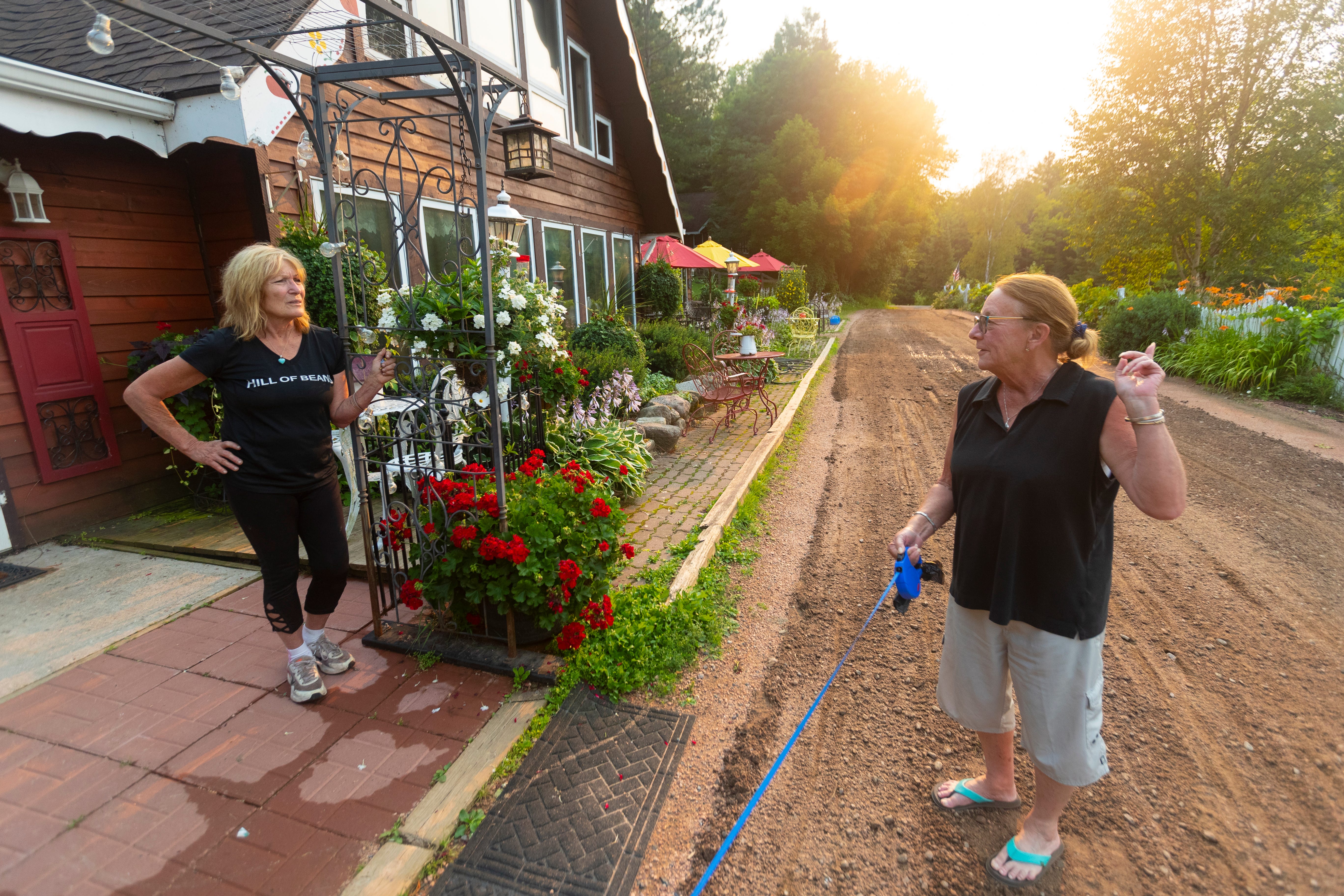 Kathleen Blomberg, left, the owner of the small High Point resort, says, about the internet, "It's always slow. I'm used to it, but people from away are not." She is chatting with guest Rowena Corbett Tuesday, July 27, 2021, at her resort wedged between two lakes in rural Price County near Ogema, Wis. Corbett, is a longtime guest from Palm Springs, Calif., who is staying at the resort for six weeks.