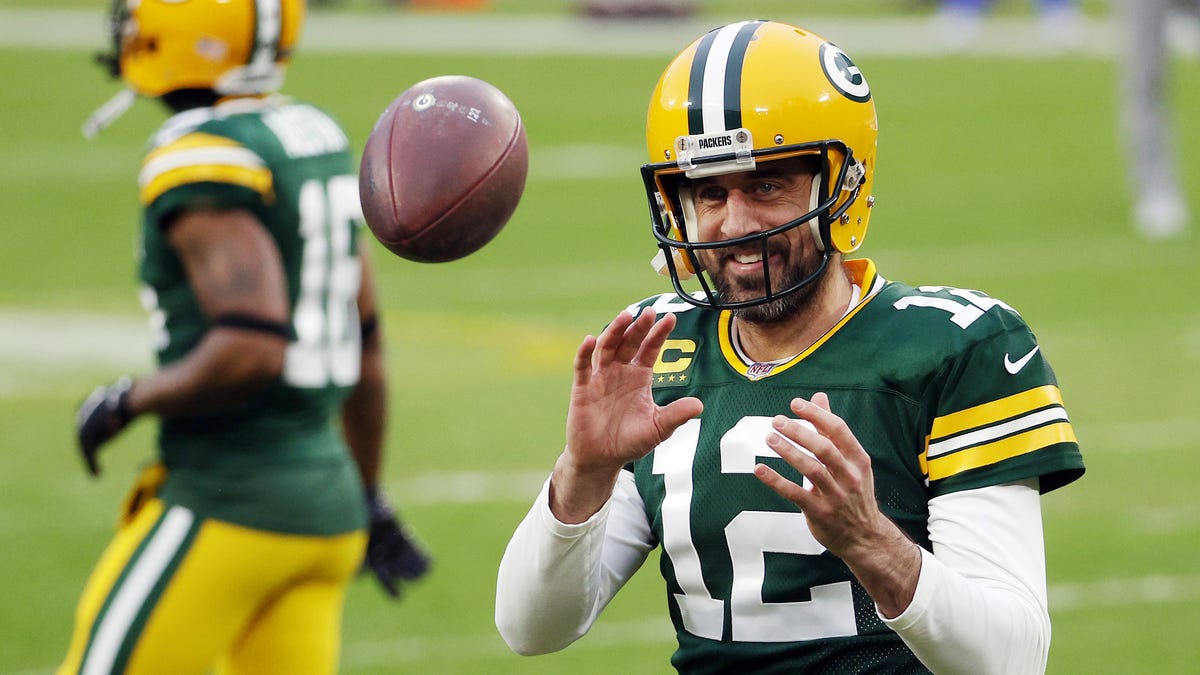 Aaron Rodgers of the Green Bay Packers warms up before the NFC Divisional Playoff game against the Los Angeles Rams at Lambeau Field on January 16, 2021 in Green Bay, Wisconsin.