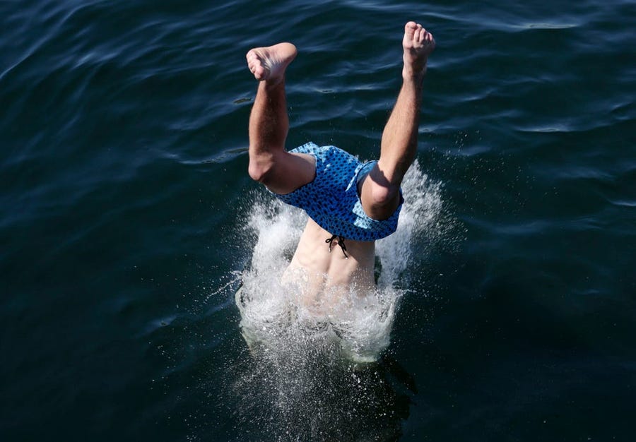 A Seattle boy takes a dive at a local park during unprecedented heat wave on June 27, 2021.