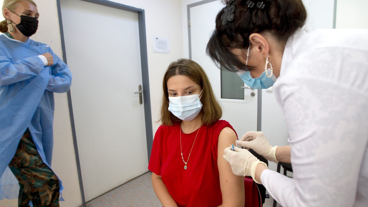 A medical worker gives an injection of Pfizer coronavirus vaccine to a woman in Tbilisi, Georgia, Tuesday, July 27, 2021. The US has donated half a million doses of the Pfizer coronavirus vaccine to Georgia, which arrived in the capital on Saturday, July 18, 2021. Georgia has registered more than 395,000 COVID-19 infections with over 5,500 deaths, according to Johns Hopkins University data. (AP Photo/Shakh Aivazov)