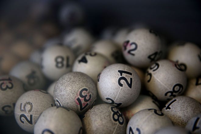 Lottery balls are seen in a box. (Photo by Justin Sullivan/Getty Images)